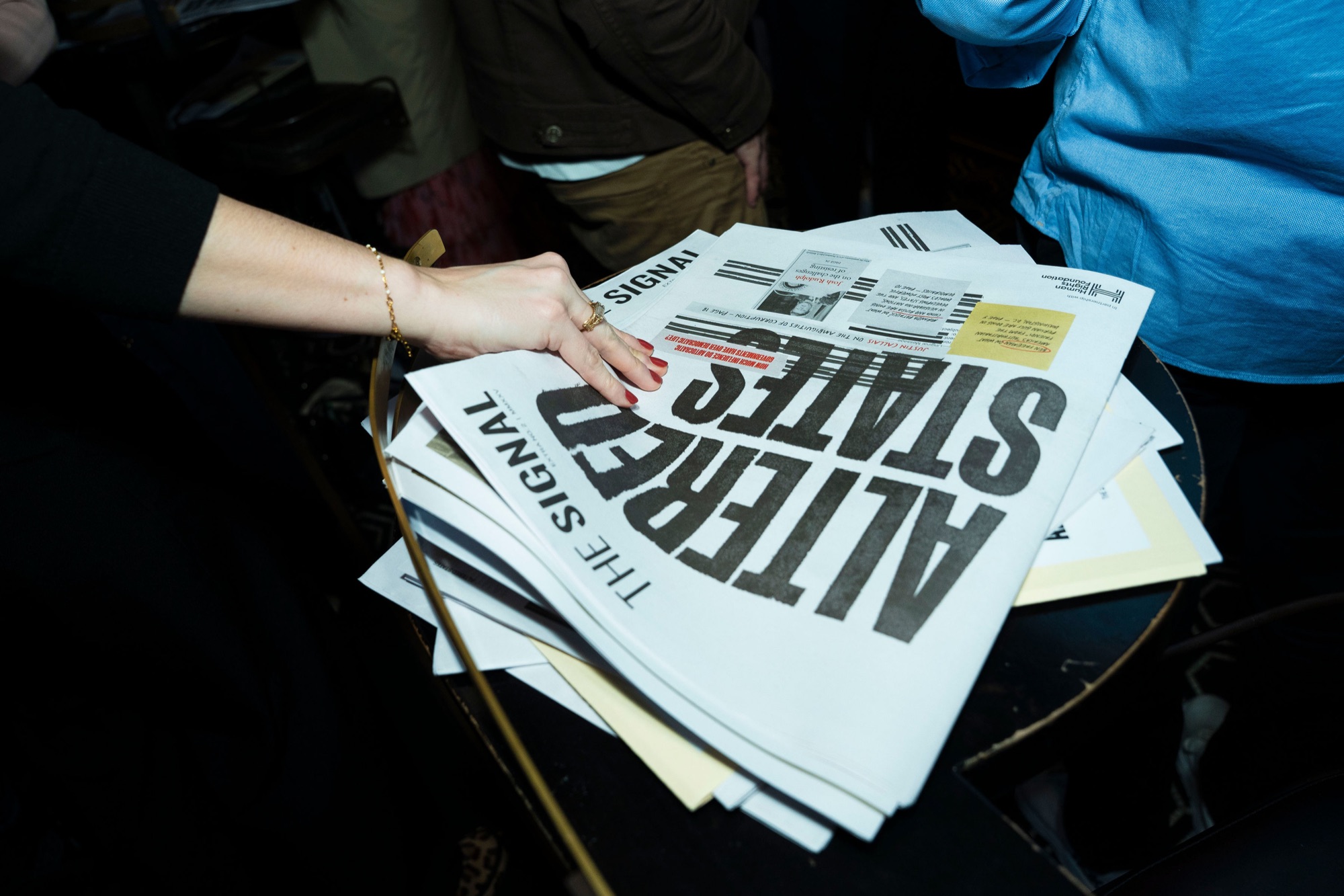 Copies of the Altered States newspaper being picked up at the Washington, D.C. launch event